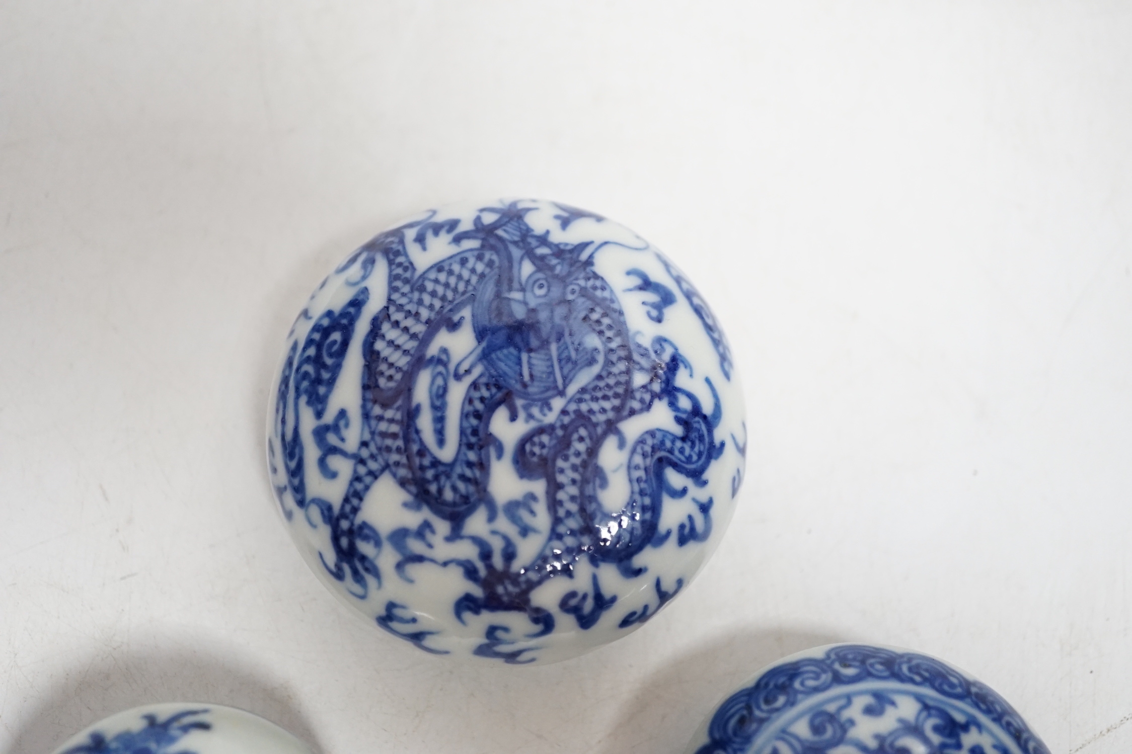 Three Chinese blue and white seal paste boxes and covers, Qing dynasty, largest 7cm in diameter
